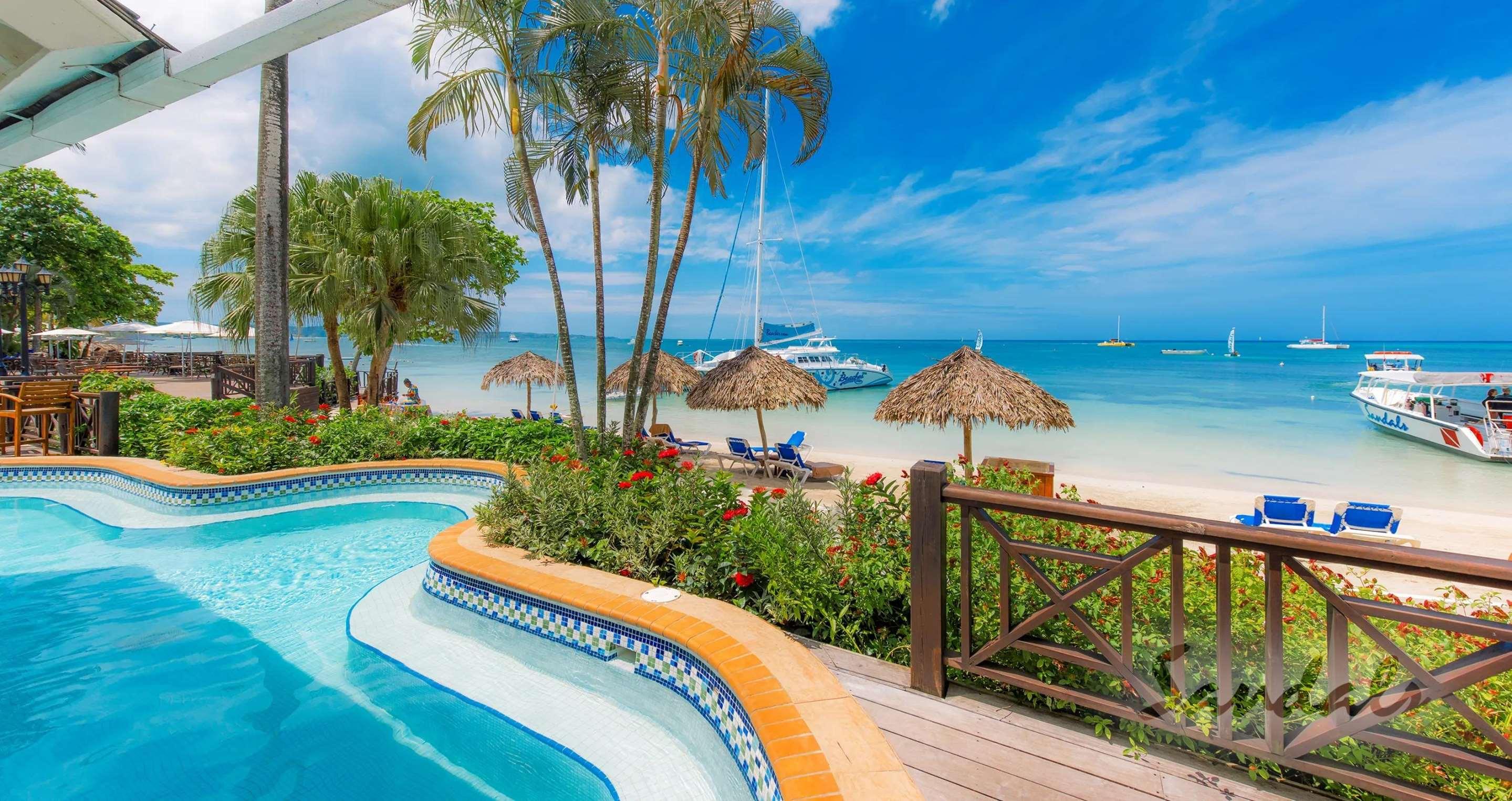 Negril, Jamaica. White sand beach at Sandals Negril Beach Resort and Spa on  Seven Mile Beach Stock Photo - Alamy